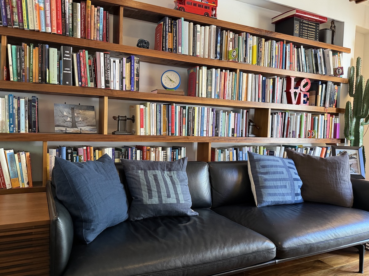 Carolyn Stevenson's therapy office in Durham, NC — bookshelves and a leather couch in natural light
